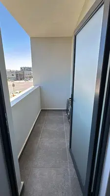 an empty room with a glass door in a building at Cape on Popham apartment in Cape Town