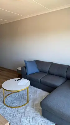 a living room with a couch and a coffee table at Cape on Popham apartment in Cape Town
