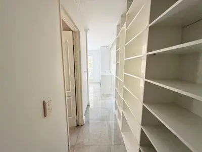 a hallway with empty shelves in a white room at Italian luxe 6 sleeper apartment near canal walk in Cape Town