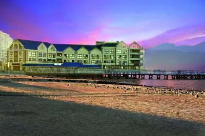 a group of buildings on a beach with a pier at The Strand Pavillion in Strand