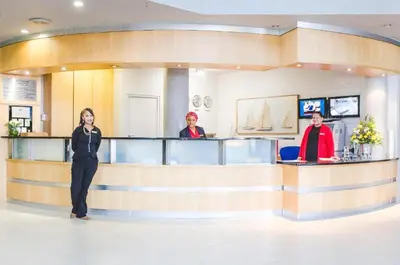 a woman standing in front of a counter in a salon at The Strand Pavillion in Strand