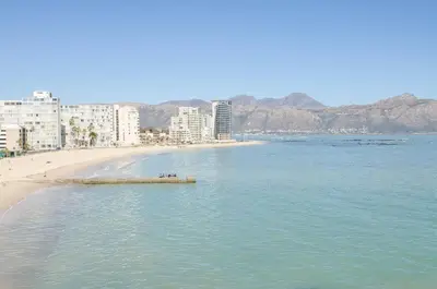 a view of a beach with buildings and the ocean at The Strand Pavillion in Strand