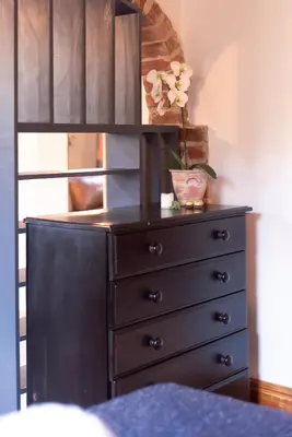a dresser with a black dresser at Mountain and Tides in Kleinmond