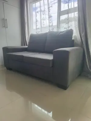 a couch sitting in front of a window at On 10 breezand road in Cape Town