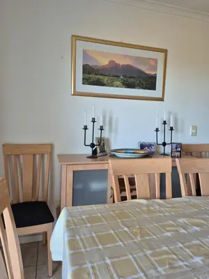 a bedroom with a bed and a table with candles at Apartment in Milnerton, Royal Ascot, Cape Town in Cape Town