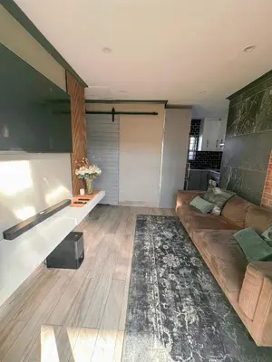a living room with a couch and a table at 29 on Windsor Rooms- in Camelot,Kuilsriver in Silver Sands