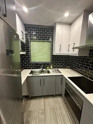 a kitchen with white cabinets and a sink at 29 on Windsor Rooms- in Camelot,Kuilsriver in Silver Sands