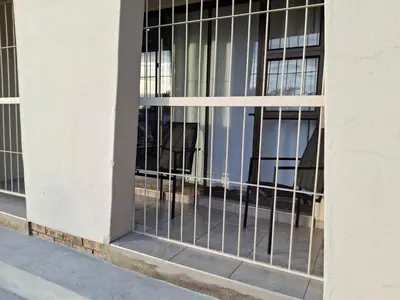 a window with bars on the side of a building at Spacious Suite in Somerset West in Somerset West
