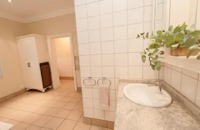 a bathroom with a sink in a room at Charming Historic Home in Central Stellenbosch in Stellenbosch