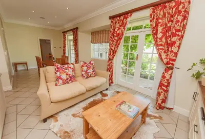 a living room with a couch and a table at Charming Historic Home in Central Stellenbosch in Stellenbosch
