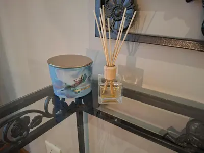 a glass table with a candle and a glass bowl on it at Spacious Suite Somerset West in Somerset West