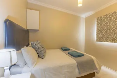 a bedroom with a bed with two pillows on it at Fleurpark 6 in Gordonʼs Bay