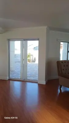 an empty living room with a sliding glass door at On The Bay in Strandfontein