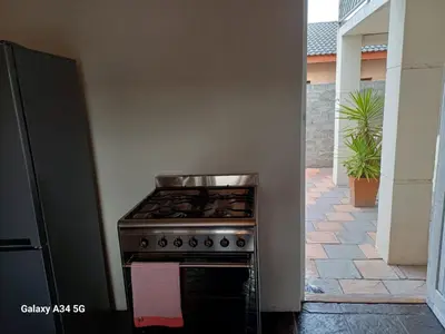 a kitchen with a stove in a room at On The Bay in Strandfontein