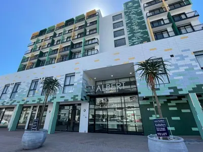 a building with two palm trees in front of it at Modern Studio at 1 on Albert with Habour View in Cape Town