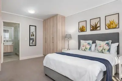 a bedroom with a large white bed with pillows at LuxeStay 2-Bed Century City Gem in Cape Town