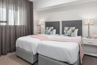 a bedroom with two beds and a window at LuxeStay 2-Bed Century City Gem in Cape Town