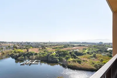 a view of a river from a balcony at LuxeStay 2-Bed Century City Gem in Cape Town