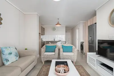 a living room with a couch and a table at LuxeStay 2-Bed Century City Gem in Cape Town