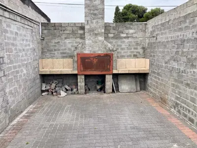 a brick wall with a fireplace with a red door at Unit 2 TraversHub Sleeps 6 Self-Catering Group Belhar, CT in Belhar