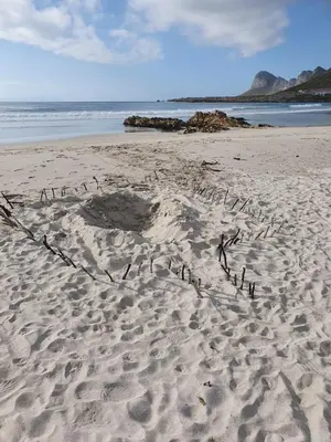 a heart drawn in the sand on a beach at Cape Holly Beach House in Pringle Bay