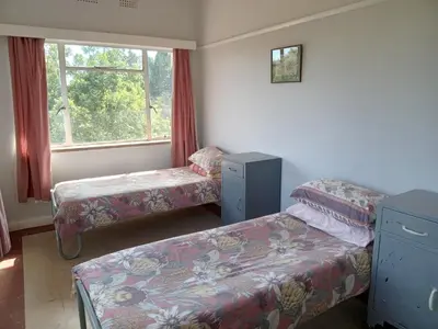 a room with two beds and a window at A Rustic and Reflective Nature Getaway in Greyton in Greyton