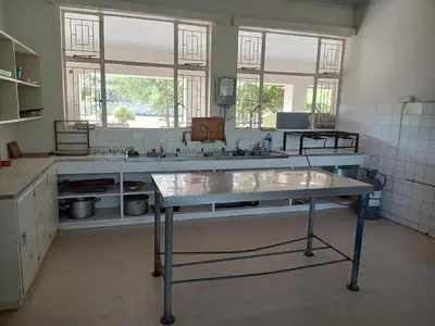 a kitchen with a table in the middle of a room at A Rustic and Reflective Nature Getaway in Greyton in Greyton