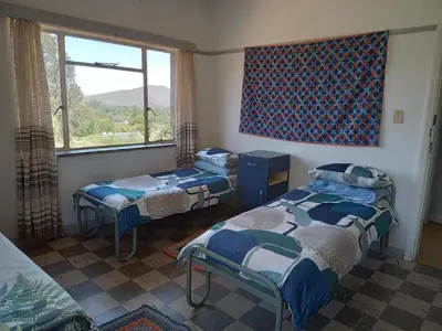 a room with two beds and a window at A Rustic and Reflective Nature Getaway in Greyton in Greyton