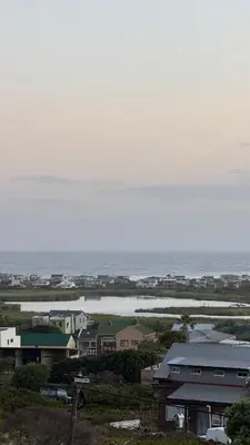 a group of houses on the beach with the ocean at Sea and Vlei on Disa in Bettyʼs Bay