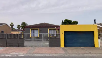 a house with a garage door and a fence at Unit 3 TraversHub Sleeps 6 Self-Catering Group Belhar, CT in Belhar