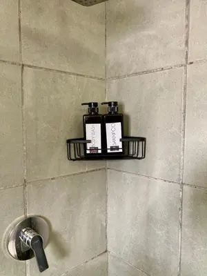 two bottles on a shelf in a bathroom at Unit 3 TraversHub Sleeps 6 Self-Catering Group Belhar, CT in Belhar