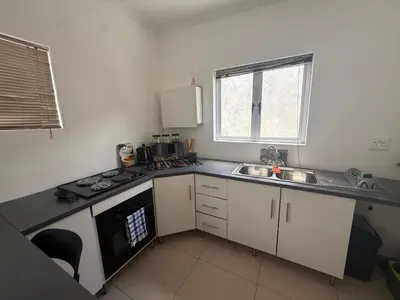 a small kitchen with a sink and a stove at Sunny Snooze Holiday Home in Goodwood