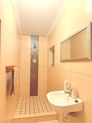 a bathroom with a sink and a shower at Sunny Snooze Holiday Home in Goodwood