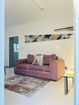a living room with a couch and a rug at Sunny Snooze Holiday Home in Goodwood