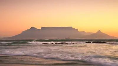 a view of the ocean with a mountain in the background at Beach Vibes Villa in Cape Town