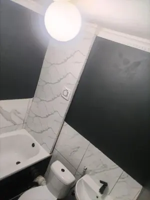 a bathroom with a white toilet and a sink at Beach Vibes Villa in Cape Town