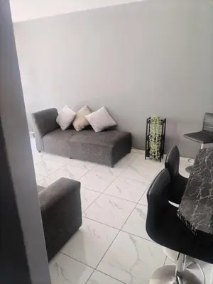 a living room with a couch and a table at Beach Vibes Villa in Cape Town