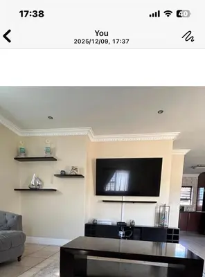 a living room with a flat screen tv on a wall at Holiday Home in Cape Town