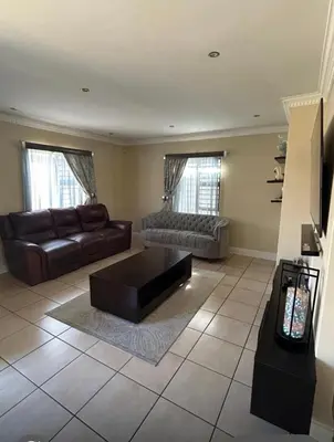 a living room with a couch and a coffee table at Holiday Home in Cape Town
