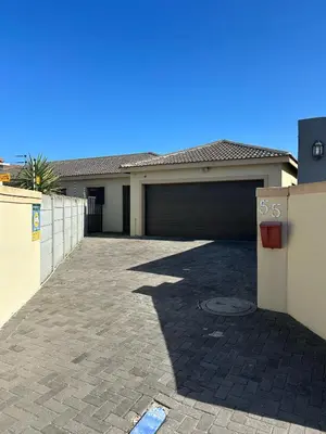 a house with a garage and a driveway at Holiday Home in Cape Town