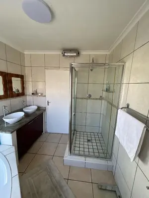a bathroom with a shower and a sink at Holiday Home in Cape Town