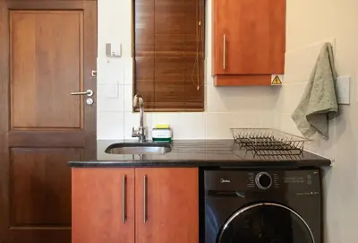 a kitchen with a sink and a dishwasher at 9 at Huis Piron - Location Stellies Central in Stellenbosch