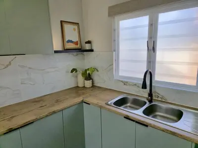 a kitchen with a sink and a window at Sand & Sea Studio Hermanus in Hermanus