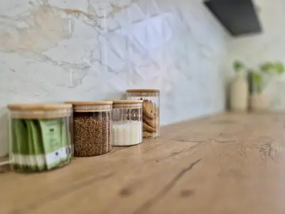 three jars of food sitting on a wooden table at Sand & Sea Studio Hermanus in Hermanus