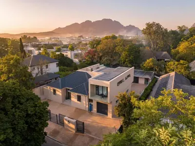 an aerial view of a house with mountains in the background at Guesthouse Ubuntu - Stellenbosch in Stellenbosch