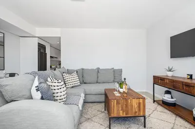 a living room with a couch and a table at Beach Break 17 in Cape Town