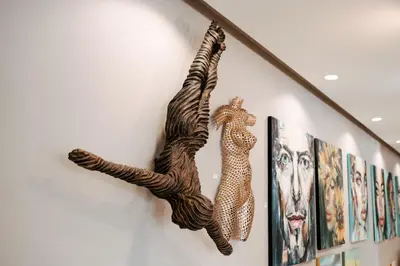 a wall decoration of a giraffe and a leopard on a wall at Krystal Beach Hotel in Gordonʼs Bay