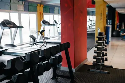 a gym with several treadmills and a treadmill at Krystal Beach Hotel in Gordonʼs Bay