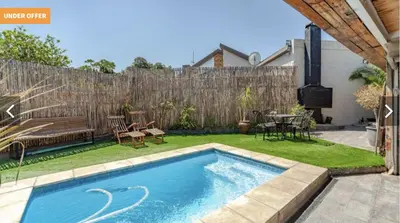 a swimming pool in a backyard with a wooden fence at Kabana Guest House Morgenzicht in Windsor Park