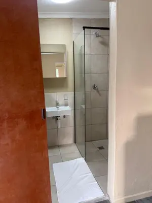 a bathroom with a shower and a sink at Kabana Guest House Morgenzicht in Windsor Park